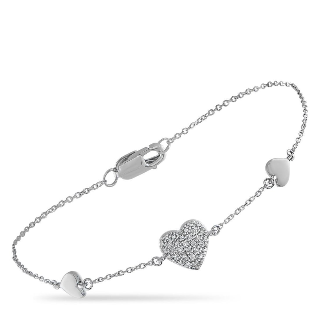 18K WHITE GOLD 0.05CT DIAMOND HEART BRACELET: This luxury bracelet is endlessly charming. A trio of stylish heart motifs elevate this pieces delicate 6.75 chain. At the center, Diamonds totaling 0.05 carats make it come alive every time it catche