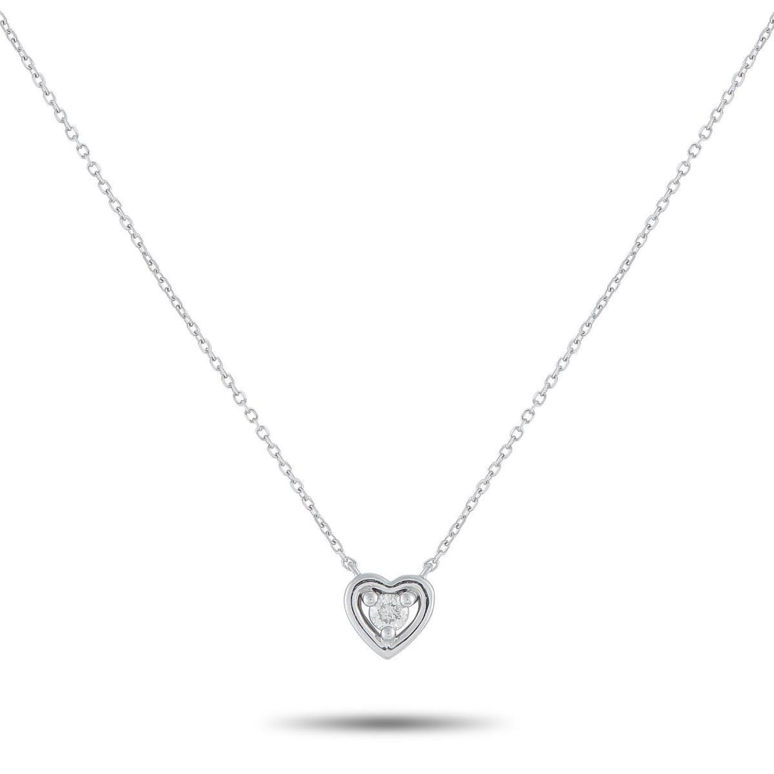 14K WHITE GOLD 0.10CT DIAMOND HEART PENDANT NECKLACE: A single 0.10 carat Diamond makes a statement at the center of this necklaces elegant, understated heart-shaped pendant. Crafted from 14K White Gold, the pendant measures 0.25 round and is suspended f