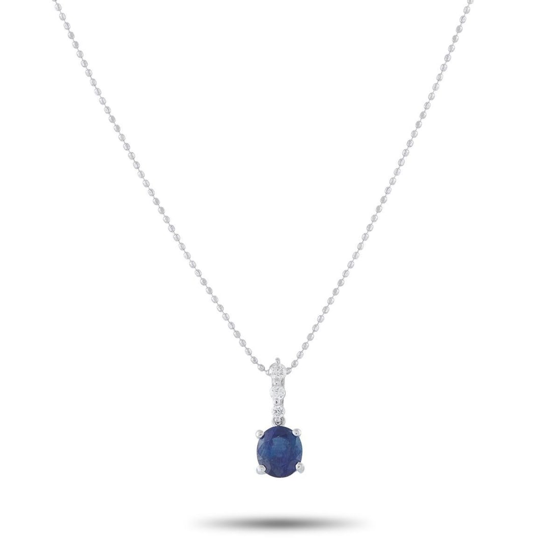18K WHITE GOLD 0.10CT DIAMOND AND SAPPHIRE PENDANT NECKLACE: This necklace will instantly add a touch of luxury to any ensemble. Set in 18K White Gold, it features a 1.08 carat Sapphire center stone accented by sparkling Diamonds totaling 0.10 carats. The penda