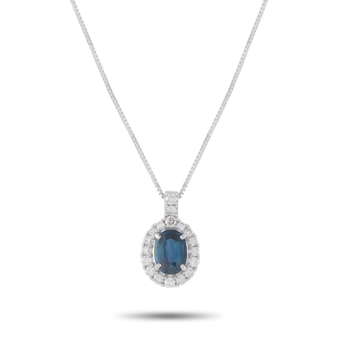 PLATINUM 0.39CT DIAMOND AND SAPPHIRE PENDANT NECKLACE: This dazzling necklace will continually captivate. Set in Platinum, it features a 1.33 carat Sapphire center stone surrounded by sparkling Diamonds totaling 0.39 carats. The pendant measures 0.64 long