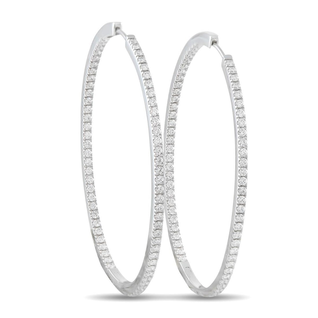 MEMOIRE 18K WHITE GOLD 1.45CT DIAMOND INSIDE-OUT OVAL HOOP EARRINGS: Add a touch of sparkle to any ensemble with these classic Memoire hoop earrings. Simple and elegant, the 18K White Gold settings are elevated by Diamonds with a total weight of 1.45 carats. Each earri