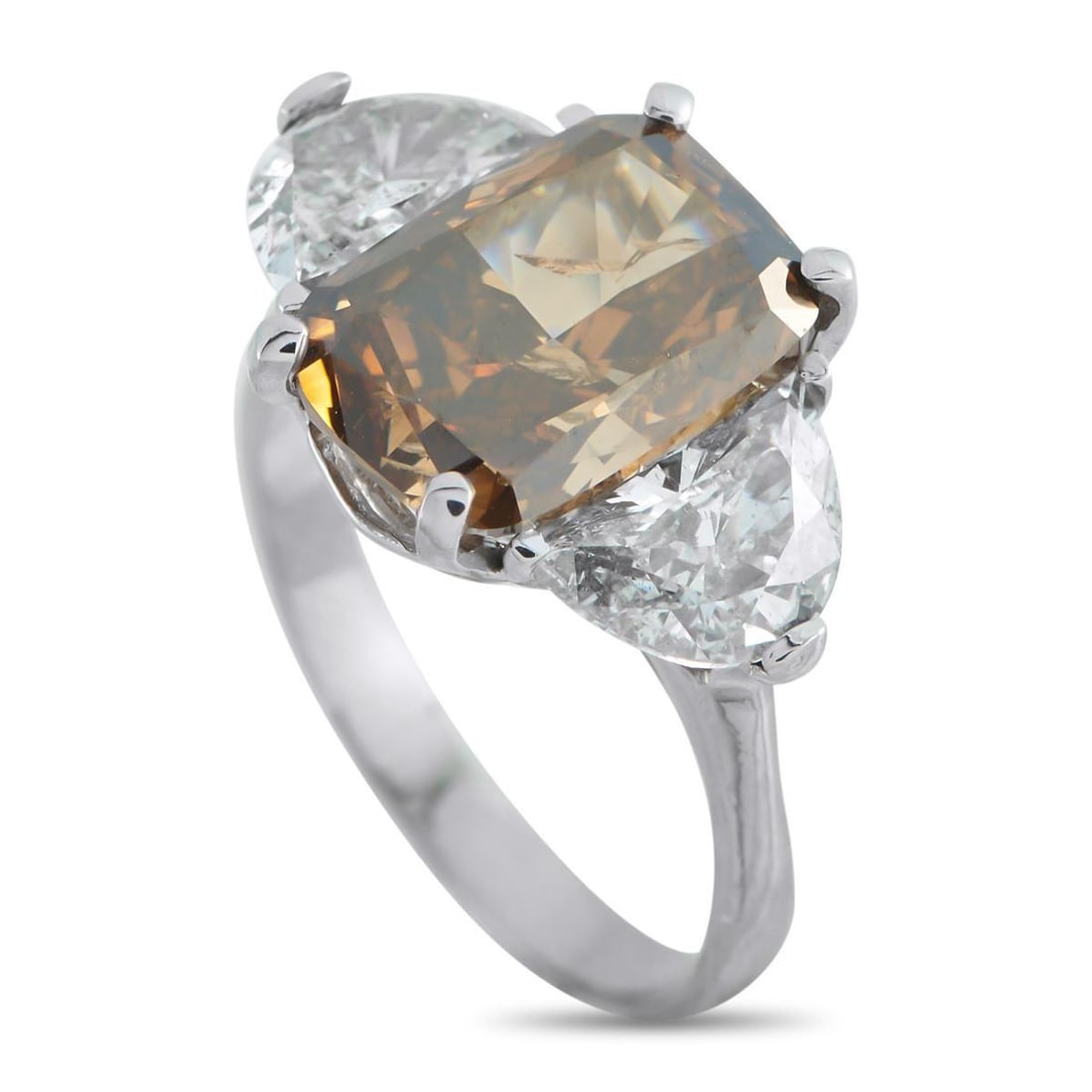PLATINUM 7.0CT DIAMOND RING: This luxury ring is truly timeless. The classically elegant design features a 5.01 carat Cognac Fancy Diamond surrounded by additional Diamonds totaling 1.99 carats. Set in Platinum, a 3mm wide band a