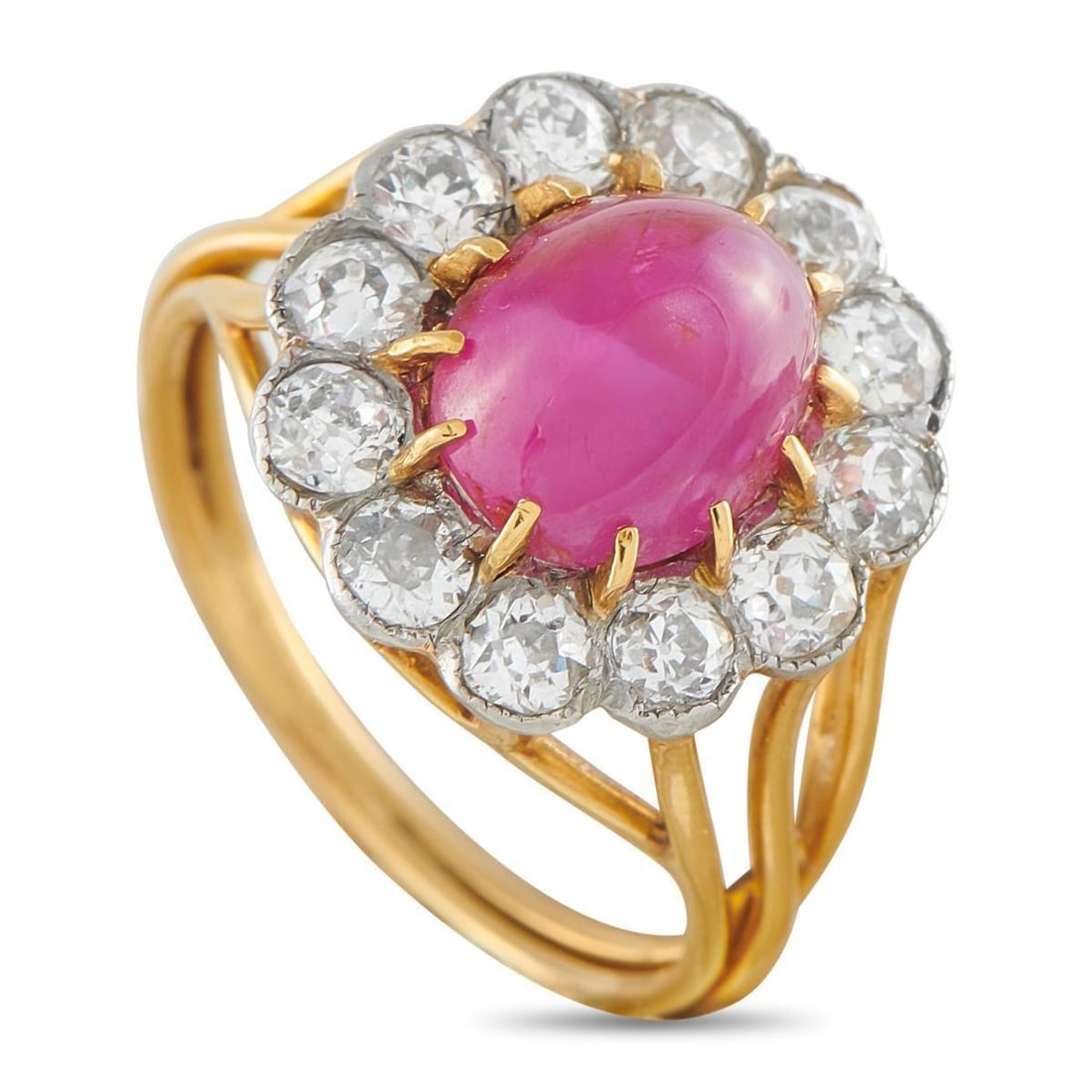 ANTIQUE 18K YELLOW GOLD 1.20CT DIAMOND AND RUBY RING: Openwork details make this antique rings 18K Yellow Gold setting incredibly delicate in design. Simple and sophisticated, it features a 3.50 carat oval cabochon ruby center stone surrounded by a halo 