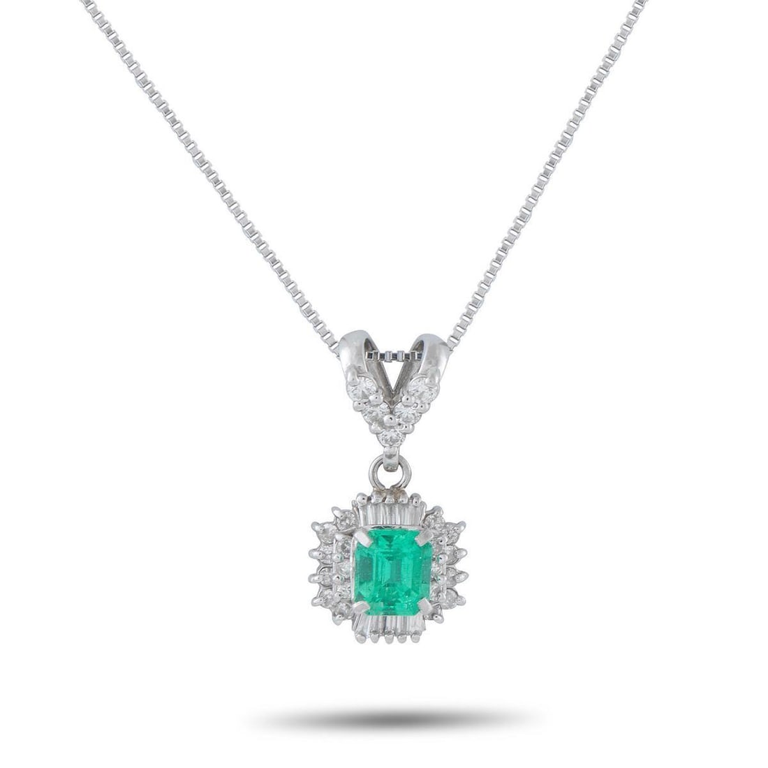 PLATINUM 0.36CT DIAMOND AND EMERALD PENDANT NECKLACE: This luxury necklace will add a touch of charm and sophistication to any ensemble. Set in Platinum, the vibrant 0.56 carat Emerald is surrounded by sparkling Diamonds totaling 0.36 carats. the pendant