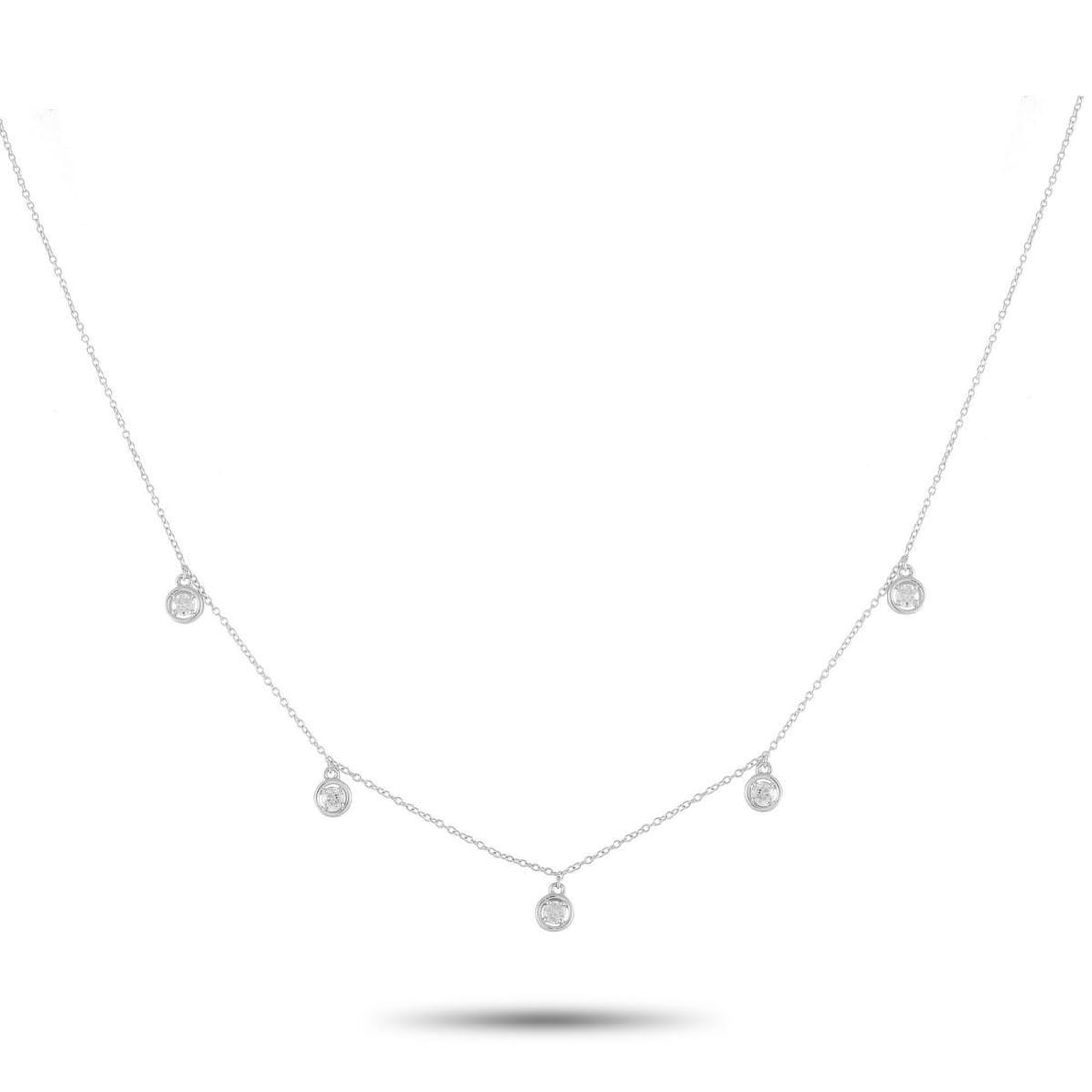 14K WHITE GOLD 0.25CT DIAMOND NECKLACE: This 14K White Gold necklace is an ideal piece for everyday wear. On this exquisite accessory, a series of bezel-set Diamonds totaling 0.25 carats are suspended from this pieces delicate 18 chain.This