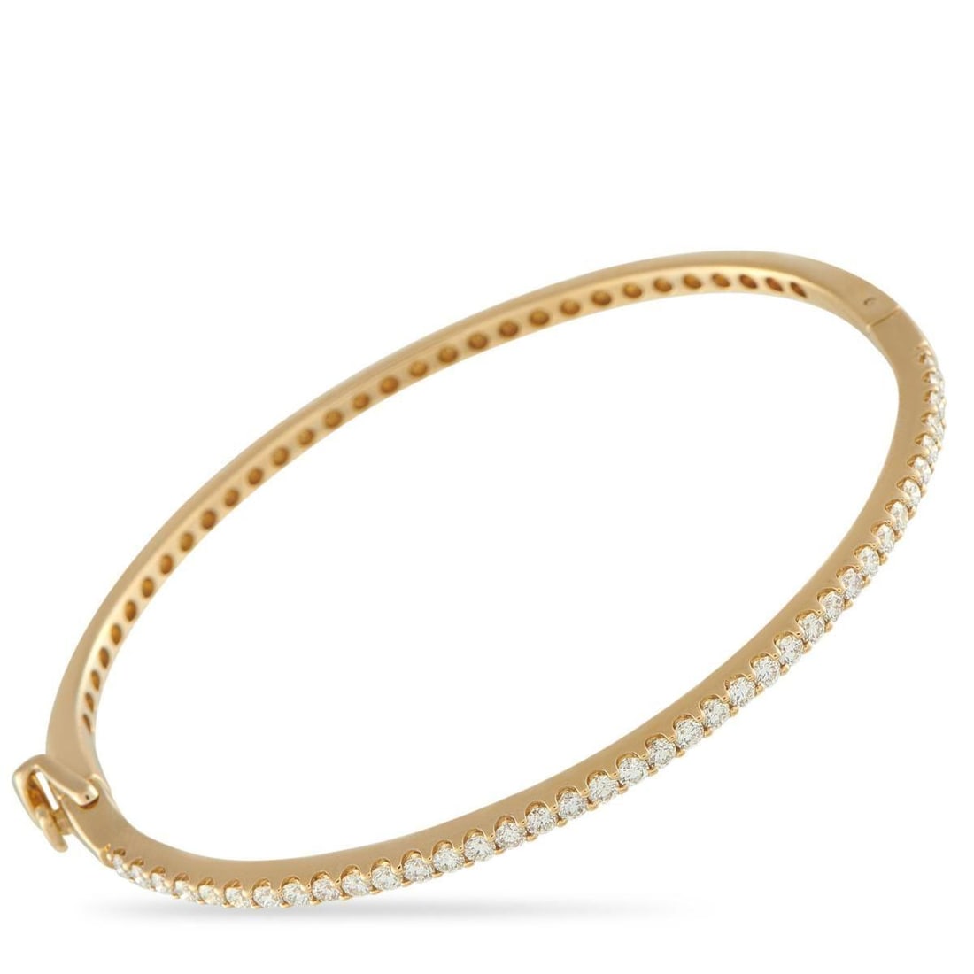 14K YELLOW GOLD 1.12CT DIAMOND BANGLE BRACELET: Smooth, hinged, and ready to layer, this bangle lifts every outfit with subtle brilliance. It features a slim silhouette, outlined by an unbroken line of diamonds for a luminous circle around the wris