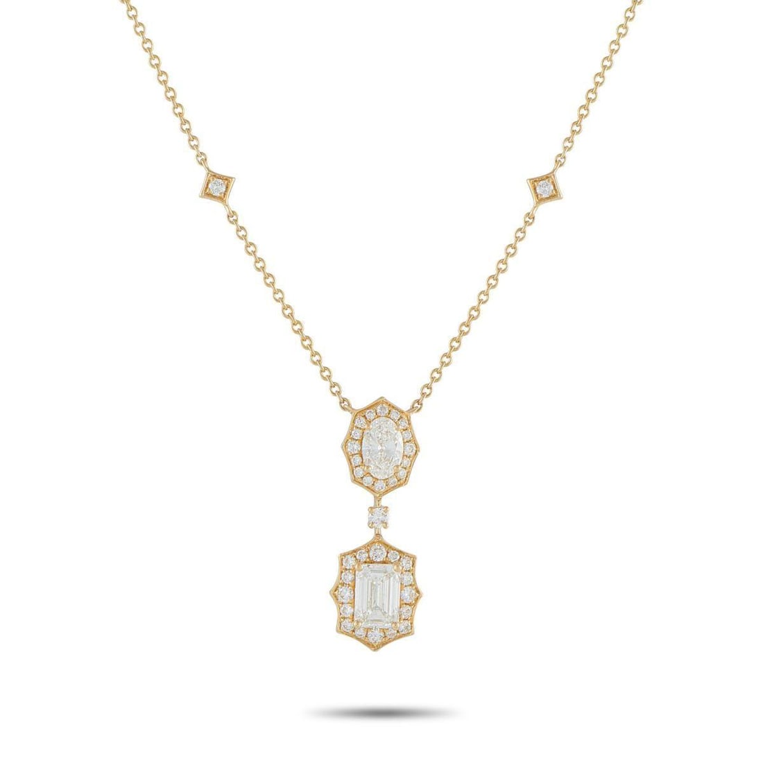 18K YELLOW GOLD 2.76CT DIAMOND GEOMETRIC NECKLACE: Warm yellow gold sets the tone for this necklace, accented by four round diamonds placed along the chain in tilted square frames. The pendant carries an oval diamond outlined by a crisp octagonal halo