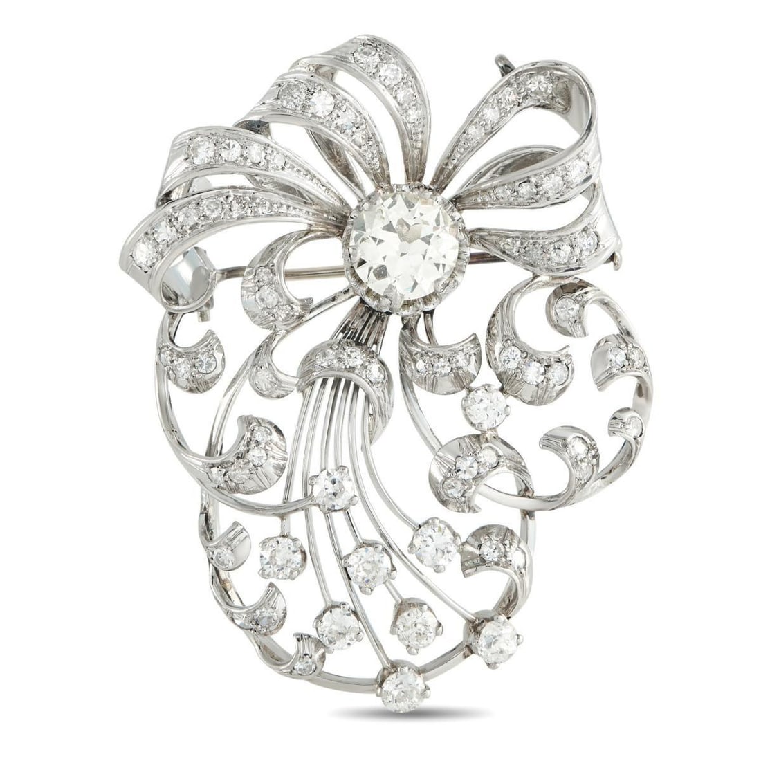 PLATINUM 4.07CT DIAMOND VICTORIAN SPRAY BROOCH: A spray of shine and sheen defines this Victorian-inspired brooch in platinum. At the core sits a 2.07-carat center diamond, from which curling diamond-set ribbons emerge. A few rigid platinum stems a