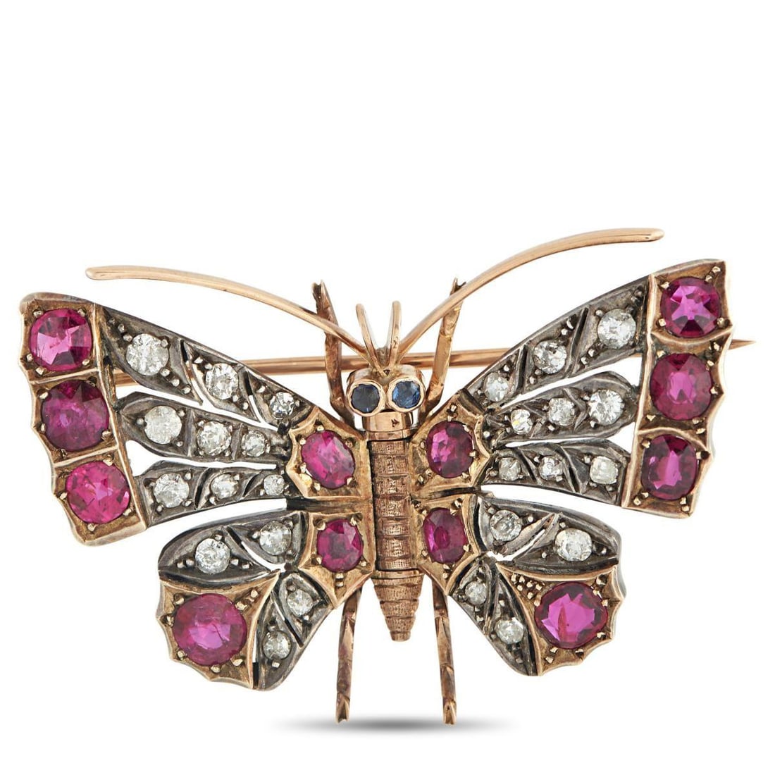 ANTIQUE 14K ROSE GOLD AND SILVER 0.80CT DIAMOND AND RUBY BUTTERFLY BROOCH: This antique brooch draws inspiration from nature. Ruby gemstones with a total weight of 3.50 carats and sparkling Diamond accents totaling 0.80 carats add color, texture, and dimension to the butterf