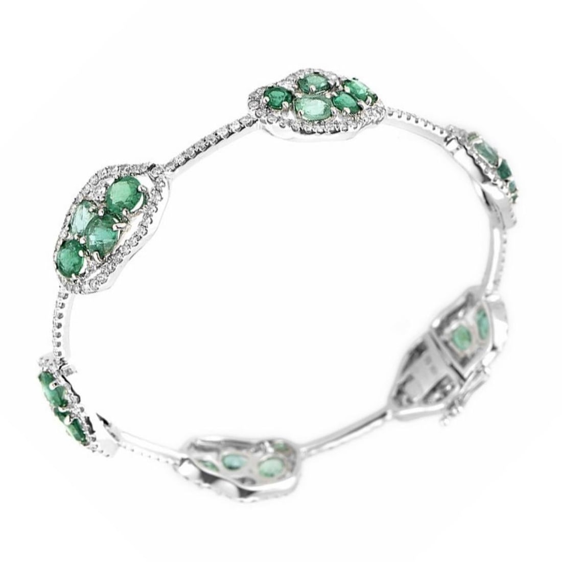 SINGLE ROW 18K WHITE GOLD DIAMOND AND EMERALD BANGLE: This bangle is magnificent and sparkles with gemstones. The bracelet is made of 18K white gold and boasts a design comprised of ~6.18ct of emeralds and ~2.30ct of diamonds. Category: Bracelet Conditio