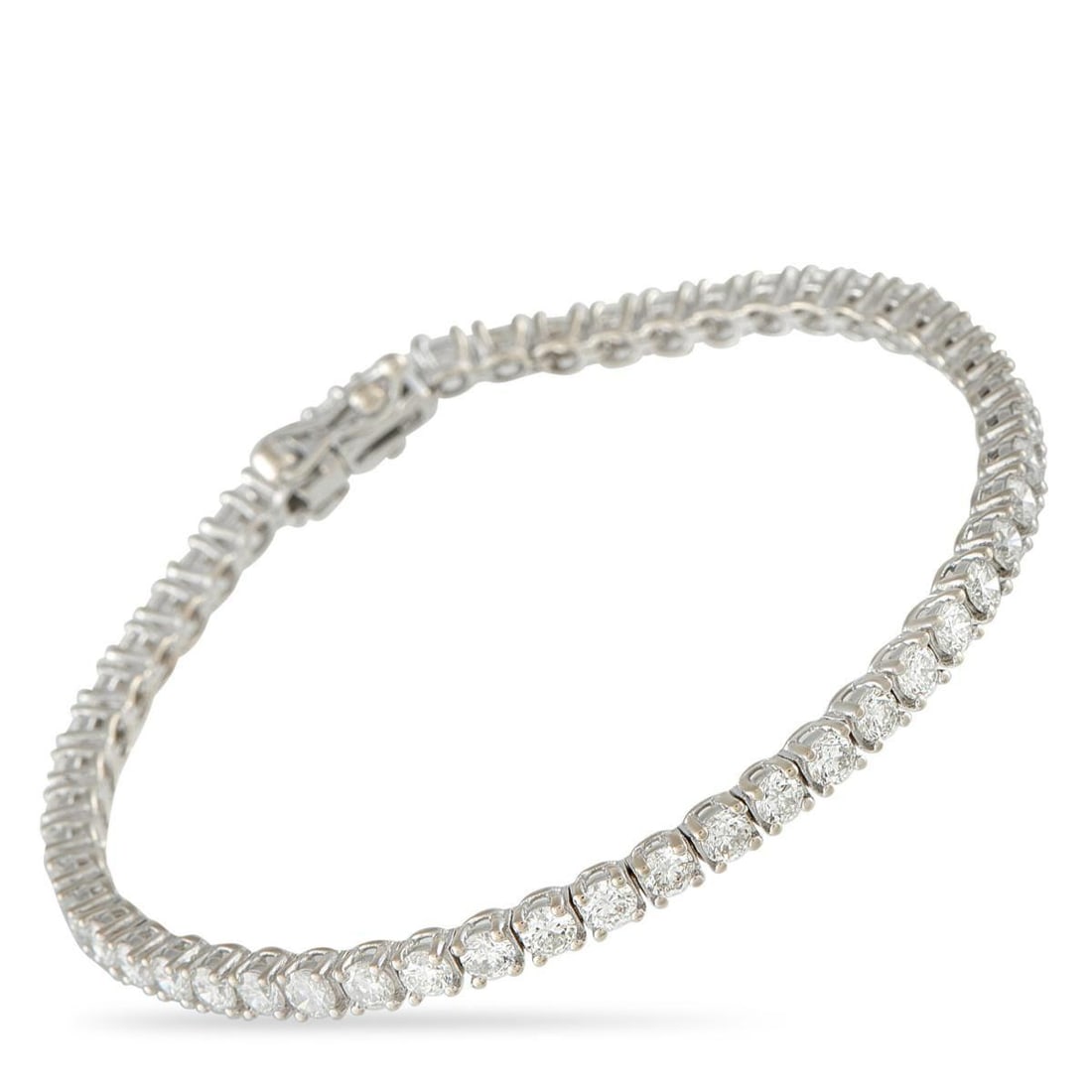 18K WHITE GOLD 3.15CT DIAMOND TENNIS BRACELET: A true statement of understated luxury. This 18K white gold tennis bracelet carries 3.15 carats of meticulously set diamonds. Each stone rests on four prongs and sits tightly against its neighbors, cr
