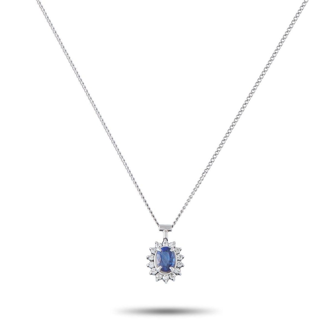 PLATINUM 0.16CT DIAMOND AND SAPPHIRE PENDANT NECKLACE: This exquisite necklace will never go out of style. Set in Platinum, it comes complete with a 0.57 carat Sapphire center stone and Diamonds totaling 0.16 carats. This pieces pendant measures 0.50 long