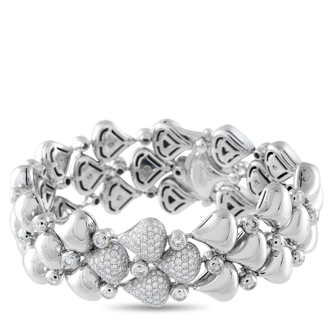 CHOPARD 18K WHITE GOLD 6.0CT DIAMOND BRACELET: This Chopard bracelet is incredibly dynamic in design. Rounded links crafted from 18K White Gold are perfectly paired with bezel-set Diamonds. At the center, additional Diamond accents provide plenty 
