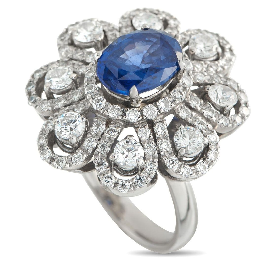 18K WHITE GOLD 1.40CT DIAMOND AND SAPPHIRE RING: This floral ring will serve as an elegant addition to any luxury jewelry collection. A stunning 2.40 carat Sapphire makes a statement at the center, while a dazzling array of Diamonds totaling 1.40 ca