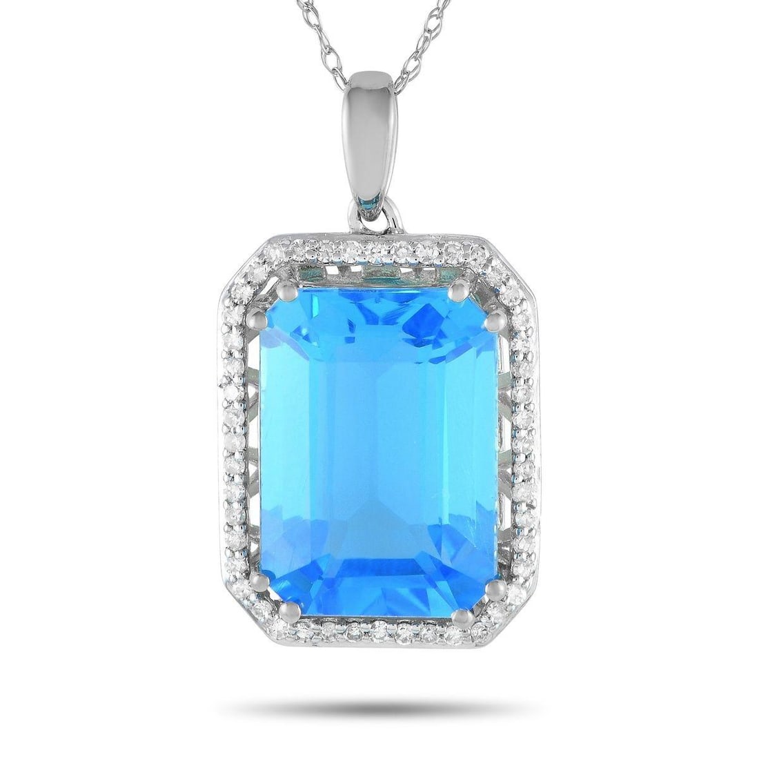 14K WHITE GOLD 0.20CT DIAMOND AND BLUE TOPAZ NECKLACE: Mark a special occasion with the exquisite beauty of this diamond and blue topaz necklace. The octagonal pendant measures 1 by 0.50 and has a frame of petite round diamonds. Sitting prominently at