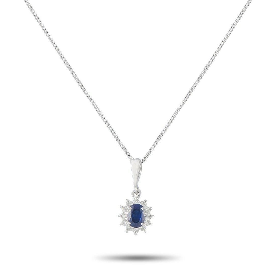 PLATINUM 0.15CT DIAMOND AND SAPPHIRE PENDANT NECKLACE: This luxury necklace is simple, elegant, and understated. The timeless design features a 0.45 carat Sapphire surrounded by a halo of Diamonds totaling 0.15 carats. Set in Platinum, this pieces pendant