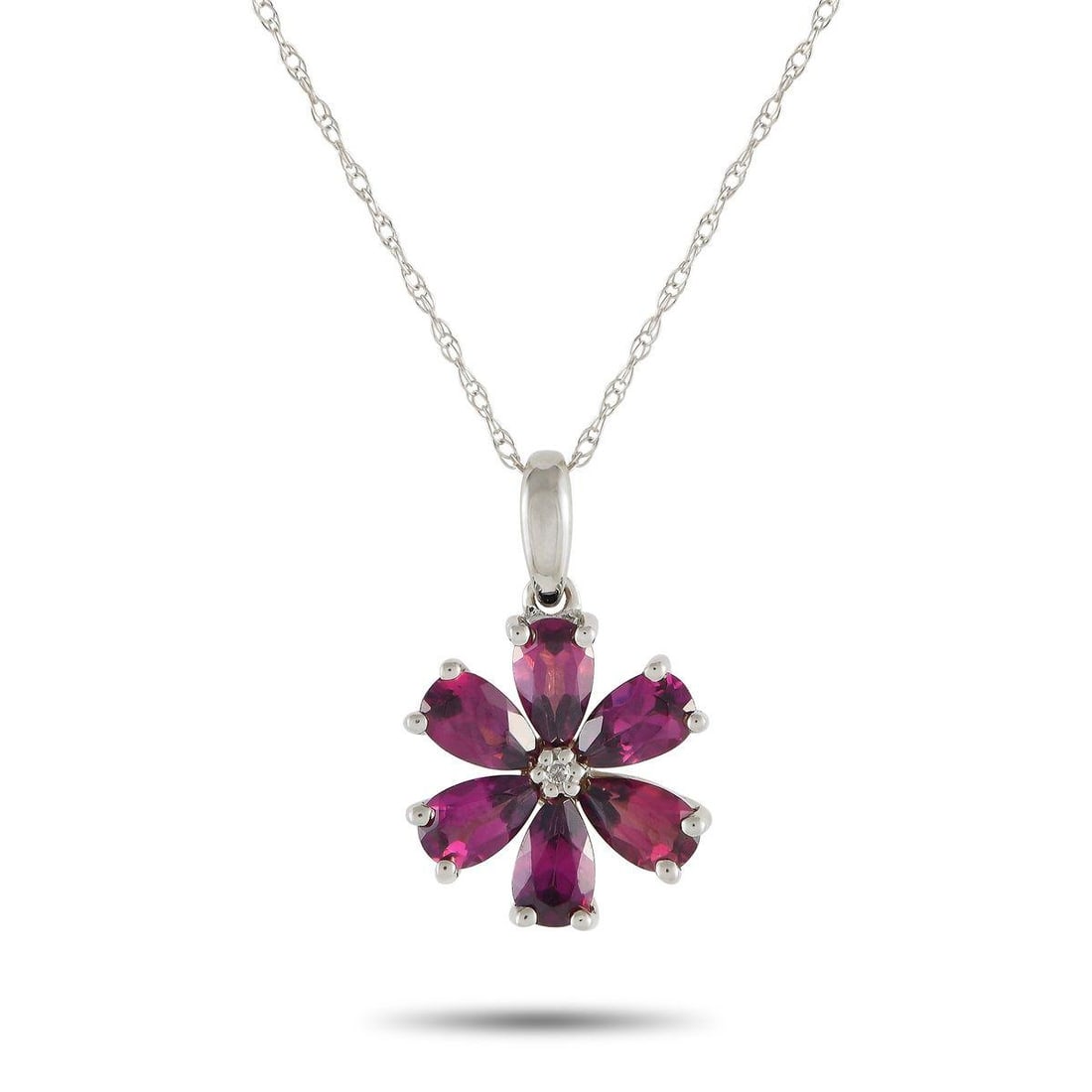 14K WHITE GOLD 0.01CT DIAMOND AND RHODOLITE FLOWER NECKLACE: Captivating rhodolite petals make this luxury necklace instantly captivating. Simple and elegant in design, the floral shaped pendant measures 0.75 long by 0.50 wide and is suspended from an 18 chain.