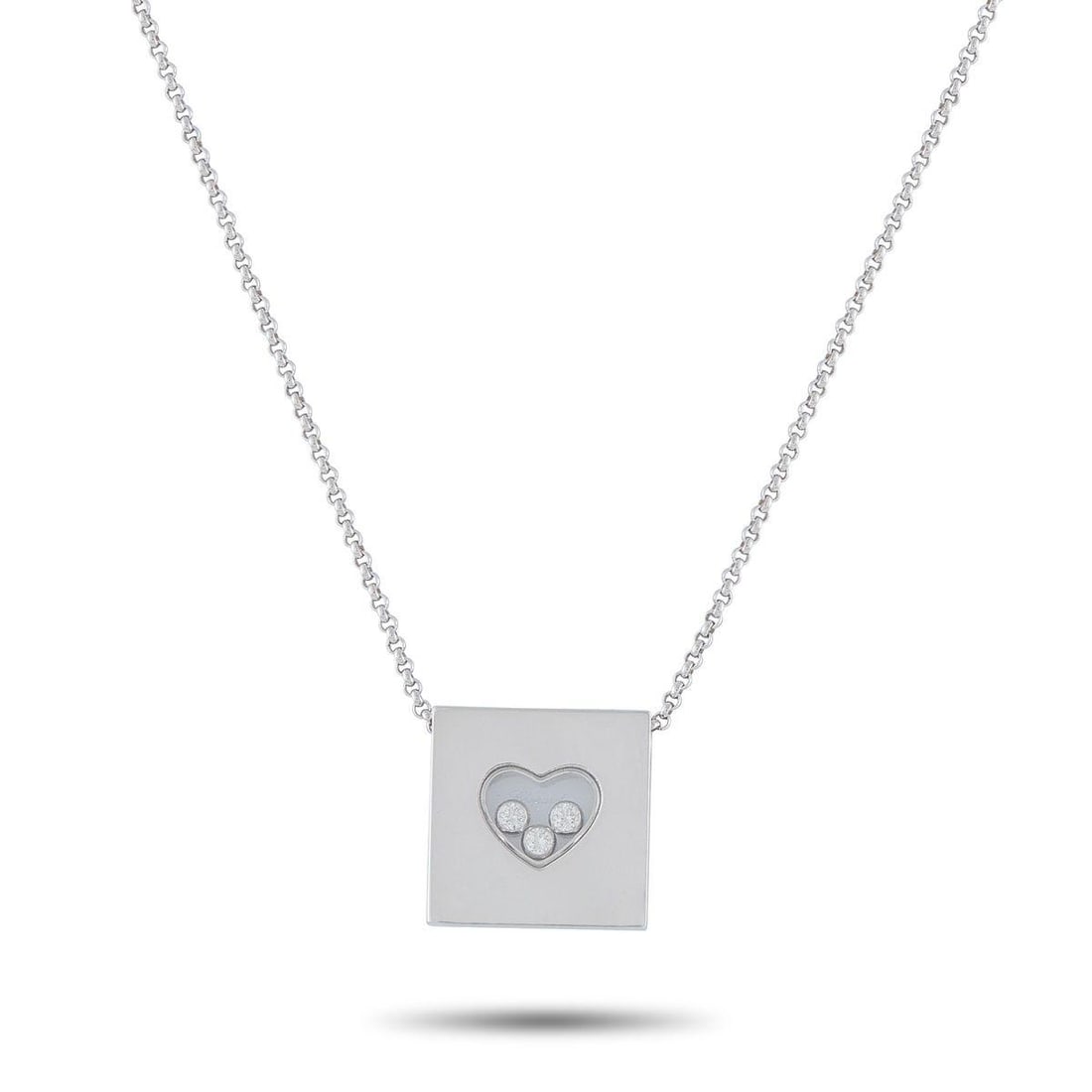 CHOPARD HAPPY DIAMONDS 18K WHITE GOLD 0.17CT DIAMOND NECKLACE: This Chopard Happy Diamonds necklace offers enduring elegance. The pendant includes a transparent heart-shaped center that contains a trio of floating Diamonds totaling 0.17 carats. Crafted from 18K W