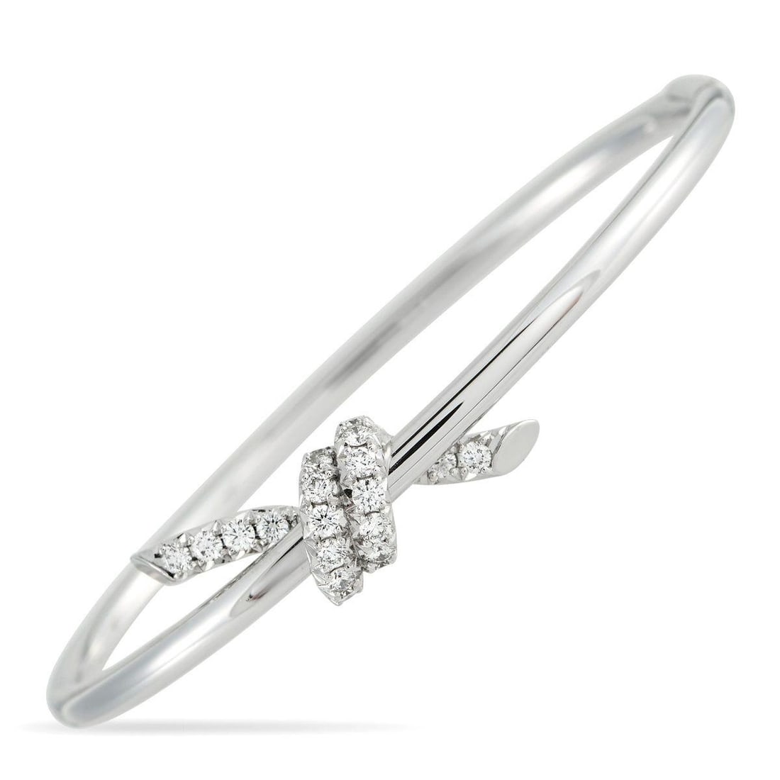 TIFFANY & CO. KNOT 18K WHITE GOLD 0.79CT DIAMOND BANGLE BRACELET: Simple and perfectly understated, this Tiffany & Co. knot bangle is meant to symbolize lifes most meaningful connections. Crafted from polished 18K White Gold, sparkling Diamonds with a total weight o