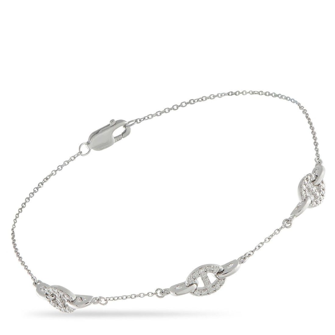 18K WHITE GOLD 0.20CT DIAMOND BRACELET: Stylish chain link motifs give this 18K White Gold bracelet a classically elegant design that will never go out of style. Elevated by Diamonds totaling 0.20 carats, this piece is simple, understated, 