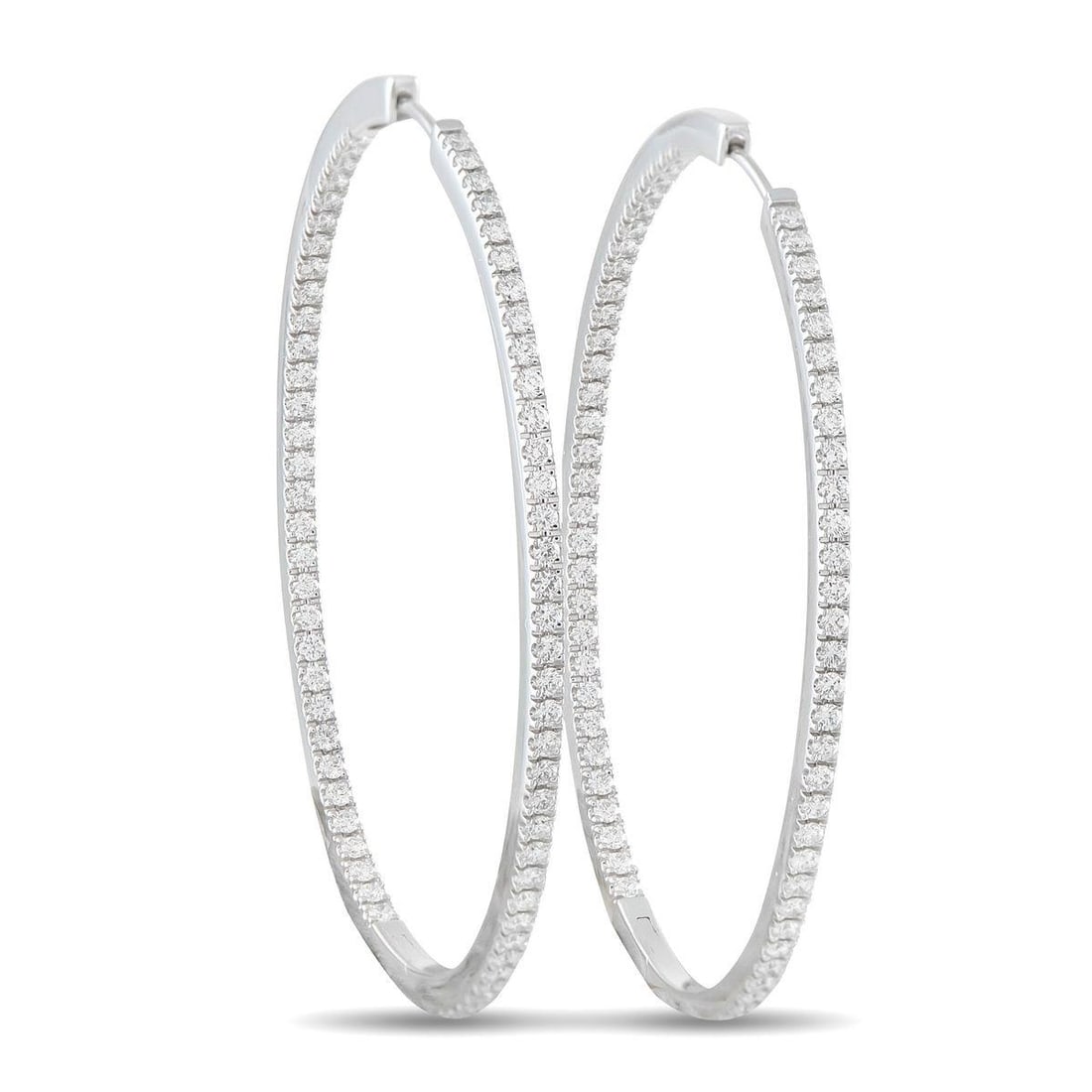 MEMOIRE 18K WHITE GOLD 1.45CT DIAMOND INSIDE-OUT OVAL HOOP EARRINGS: Add a touch of sparkle to any ensemble with these classic Memoire hoop earrings. Simple and elegant, the 18K White Gold settings are elevated by Diamonds with a total weight of 1.45 carats. Each