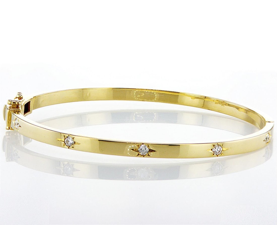 14k yellow gold 0.95ctw Diamond Bracelet: One 14k yellow gold bangle bracelet (585 stamped), set with natural diamonds. Jewelry Weight: 20.49Grs Total Diamonds Weight: 0.95Cts Main Stones Description: Cut and shape: Round Brilliant Carats Wei