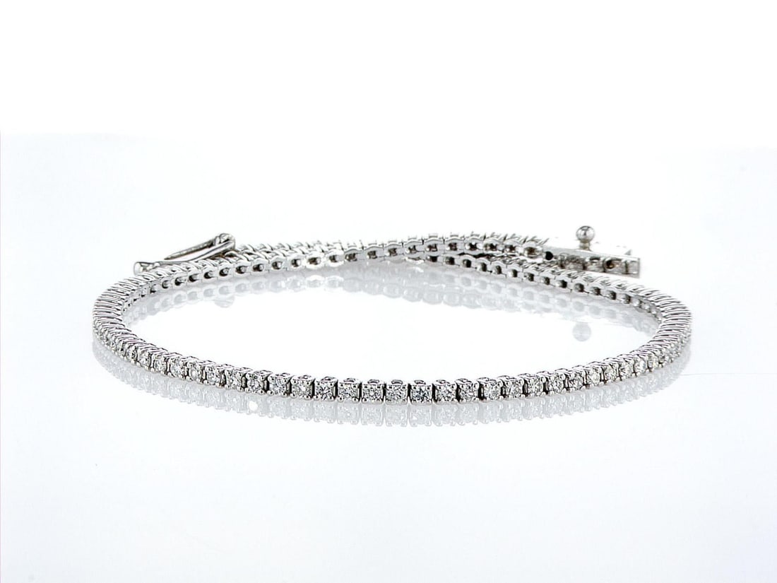 14kt White Gold 1.08ctw Diamond Tennis Bracelet: One 14k white gold bracelet "Tennis" (585 stamped), set with natural diamonds. Jewelry Weight: 5.17Grs Total Diamonds Weight: 1.08Cts Main Stones Description: Quantity: 100 Cut and shape: Round
