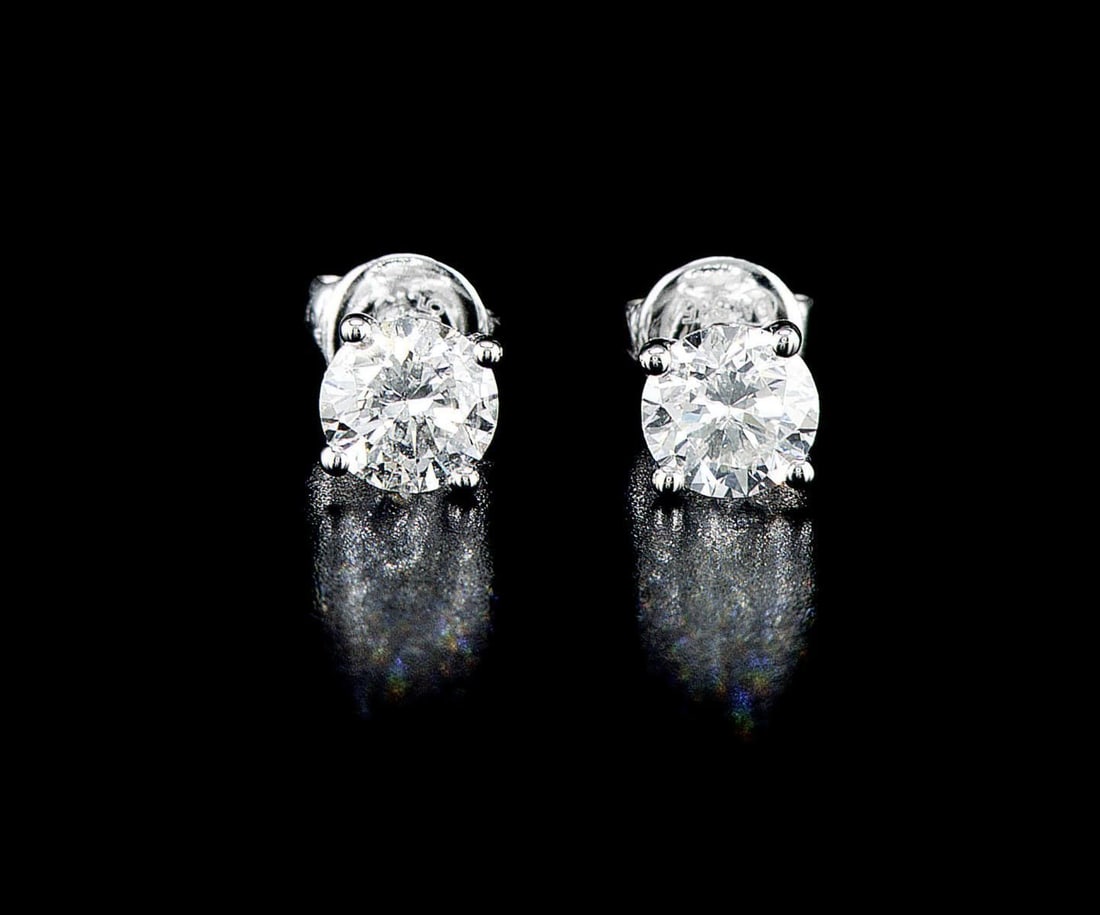14kt White Gold 1.47ctw Diamond Earrings: One pair of 14k white gold earrings (585 stamped), each set with one natural diamond. Jewelry Weight: 1.63Grs Total Diamonds Weight: 1.74Cts Main Stones Description: Quantity: 2 Cut and shape: Round B