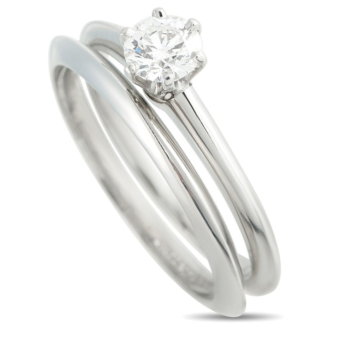 TIFFANY & CO. PLATINUM 0.45CT DIAMOND RING AND WEDDING BAND SET: This Tiffany & Co. ring set is ideal for anyone who appreciates timeless luxury. This two-piece set comes complete with a Platinum ring featuring a 0.45 carat Diamond center stone and a matching Plati