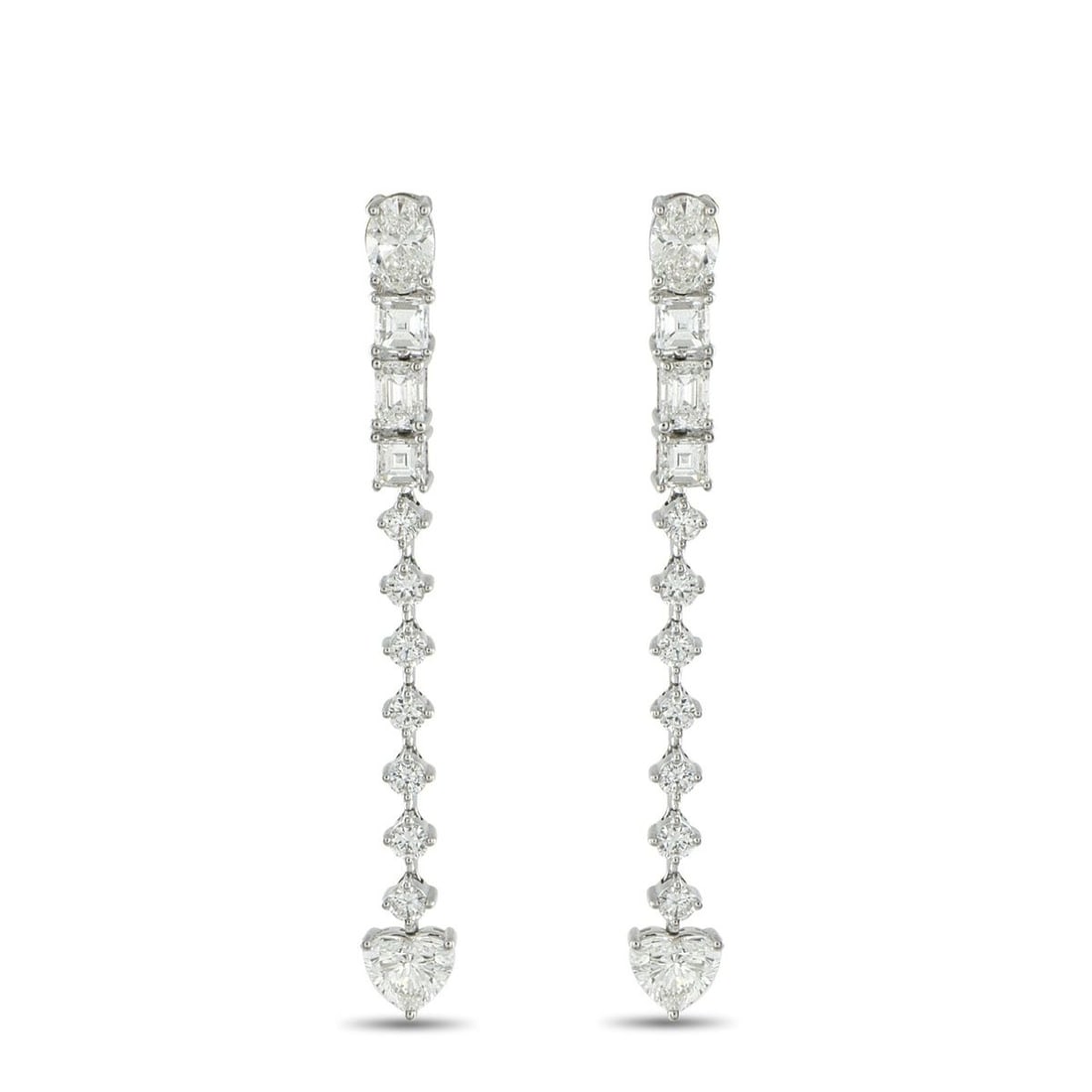 18K WHITE GOLD 3.95CT DIAMOND DANGLE EARRINGS: Geometry meets romance in these 18K white gold dangle earrings. Like a story told in facets, these earrings begin with an oval diamond at the post. Step-cut diamonds mark the rhythm, followed by a ver