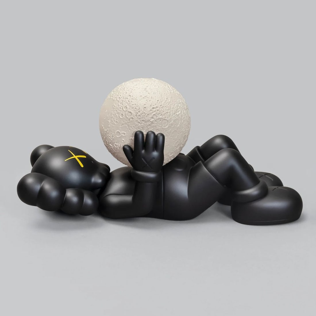 Kaws- Vinyl, with a fluorescent moon component "HOLIDAY SHANGHAI (Black)": Artist: Kaws. Medium: Vinyl, with a fluorescent moon component. Title: HOLIDAY SHANGHAI (Black). Size: 9.5" x ". Certificate of Authenticity: Is included. Reference#: 69222.