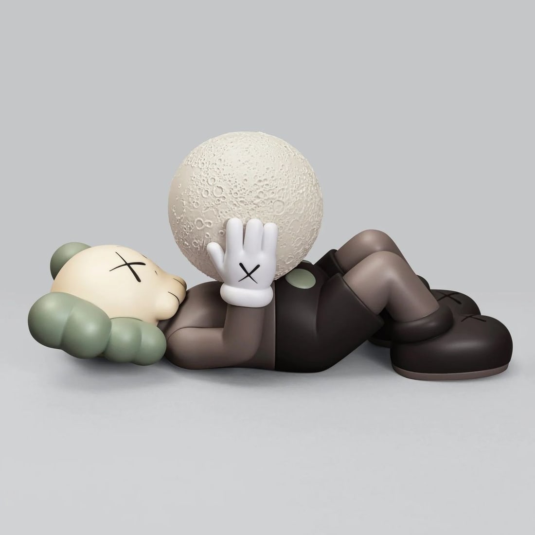 Kaws- Vinyl, with a fluorescent moon component "HOLIDAY SHANGHAI (Brown)": Artist: Kaws. Medium: Vinyl, with a fluorescent moon component. Title: HOLIDAY SHANGHAI (Brown). Size: 9.5" x ". Certificate of Authenticity: Is included. Reference#: 69221.