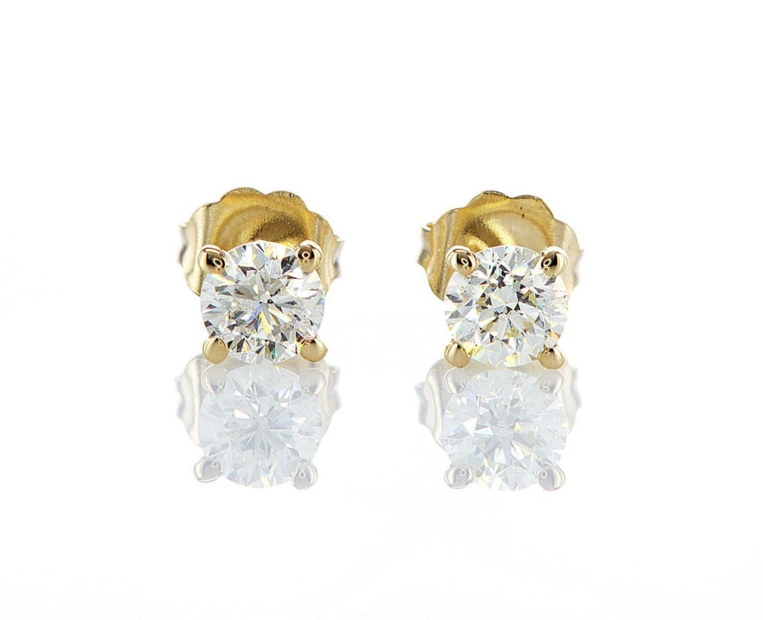 14kt Yellow Gold 0.78ctw Diamond Earrings: One pair of 14k yellow gold earrings, each set with one natural diamond. Jewelry Weight: 0.81Grs Total Diamonds Weight: 0.78Cts Main Stones Description: Quantity: 2 Cut and shape: Round Brilliant Cara