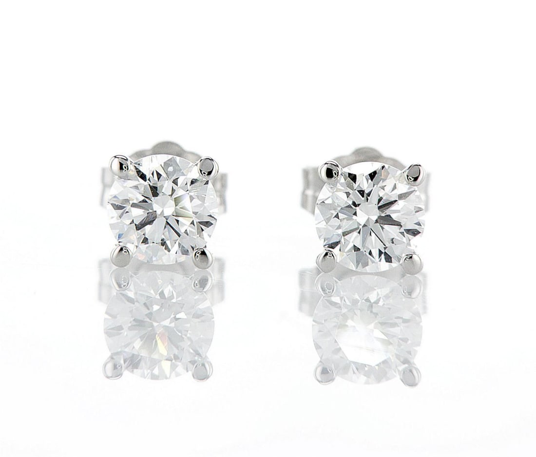 14kt White Gold 1.06ctw Diamond Earrings: One pair of 14k white gold earrings (14k stamped), each set with one lab grown diamond. Jewelry Weight: 1Grs Total Diamonds Weight: 1.06Cts Main Stones Description: Quantity: 2 Cut and shape: Round Br