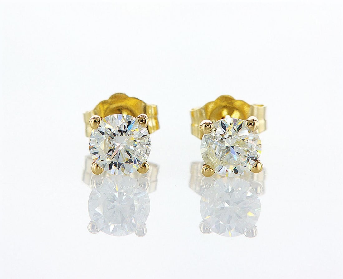 14kt Yellow Gold 0.88ctw Diamond Earrings: One pair of 14k yellow gold earrings (14k stamped), each set with one natural diamond Jewelry Weight: 0.81Grs Total Diamonds Weight: 0.88Cts Main Stones Description: Quantity: 2 Cut and shape: Round B