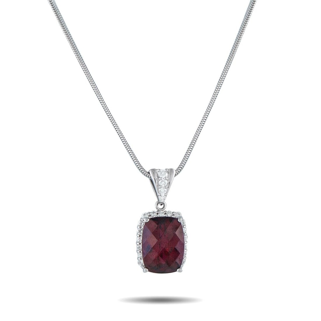 PLATINUM 0.80CT DIAMOND AND RHODOLITE GARNET PENDANT NECKLACE: On this exquisite necklace, a 14.40 carat Rhodolite Garnet gemstone provides a stylish pop of color. Set in Platinum, the pendant measures 1.13 long by 0.50 wide and is suspended from a 19 chain. Diam