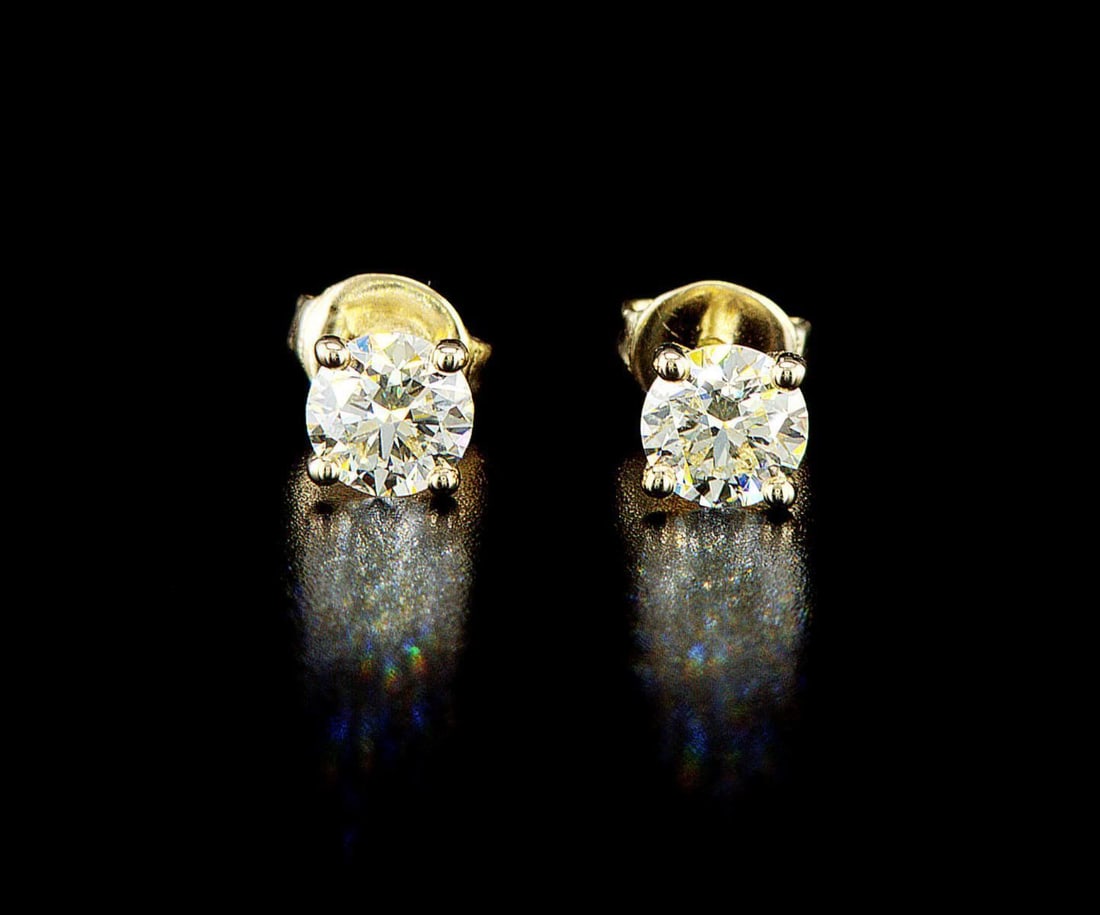 14k yellow gold 1.18ctw Diamond Earrings: One pair of 14k yellow gold earrings (585 stamped), each set with one natural diamond. Jewelry Weight: 1.49Grs Total Diamonds Weight: 1.18Cts Main Stones Description: Quantity: 2 Cut and shape: Round 