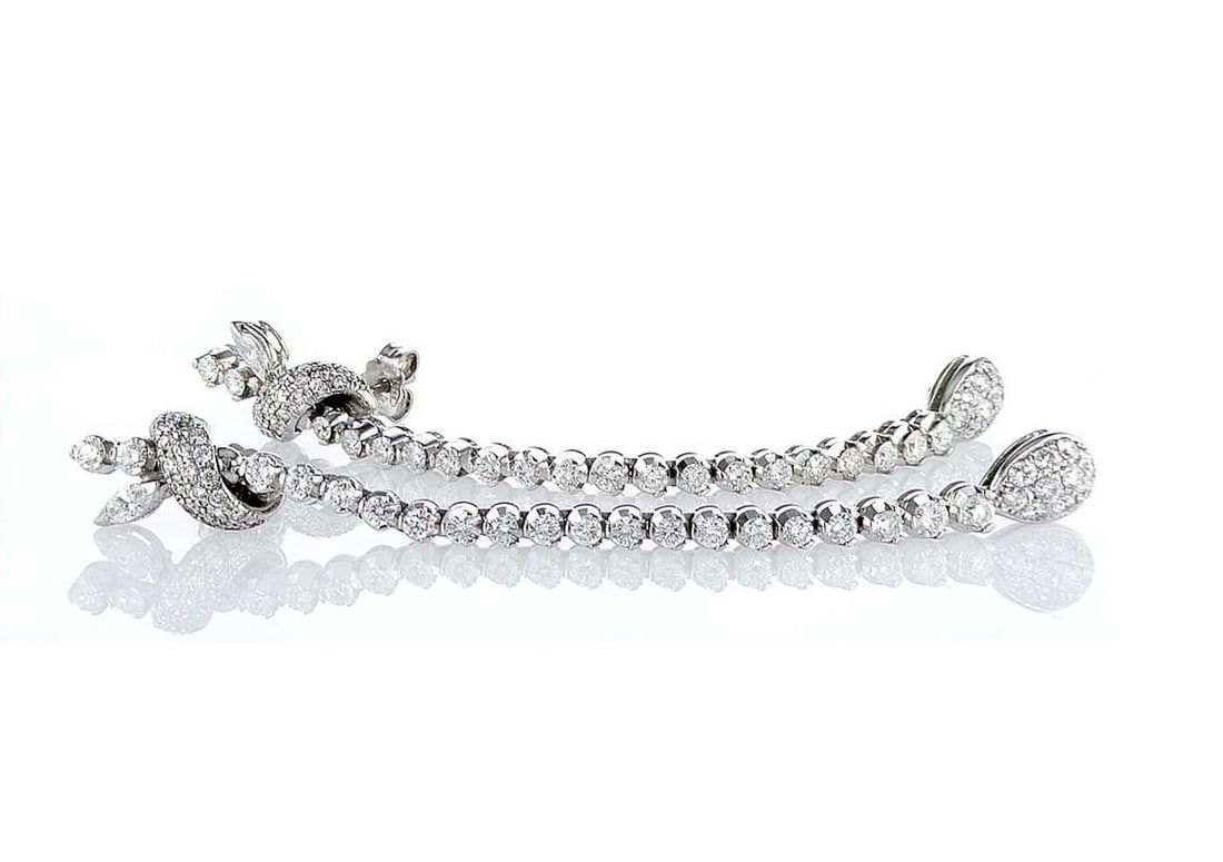 18kt White Gold 3.6ctw Diamond Earrings: One pair of 18k white gold earrings (750 stamped), each set with natural diamonds. Jewelry Weight: 13.62Grs Total Diamonds Weight: 3.6Cts Main Stones Description: Quantity: 104 Cut and shape: Round Br