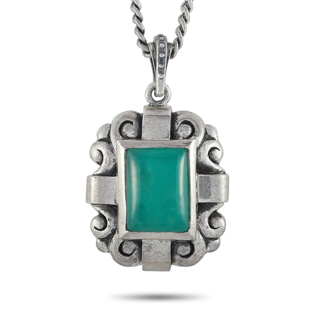 KING BABY SILVER AND CHRYSOPRASE SCROLLWORK PENDANT NECKLACE: This King Baby necklace is crafted from silver and weighs 54.2 grams. The necklace is presented with a 22 chain onto which a 2 by 1.25 pendant is attached, set with a chrysoprase.Offered in brand new 