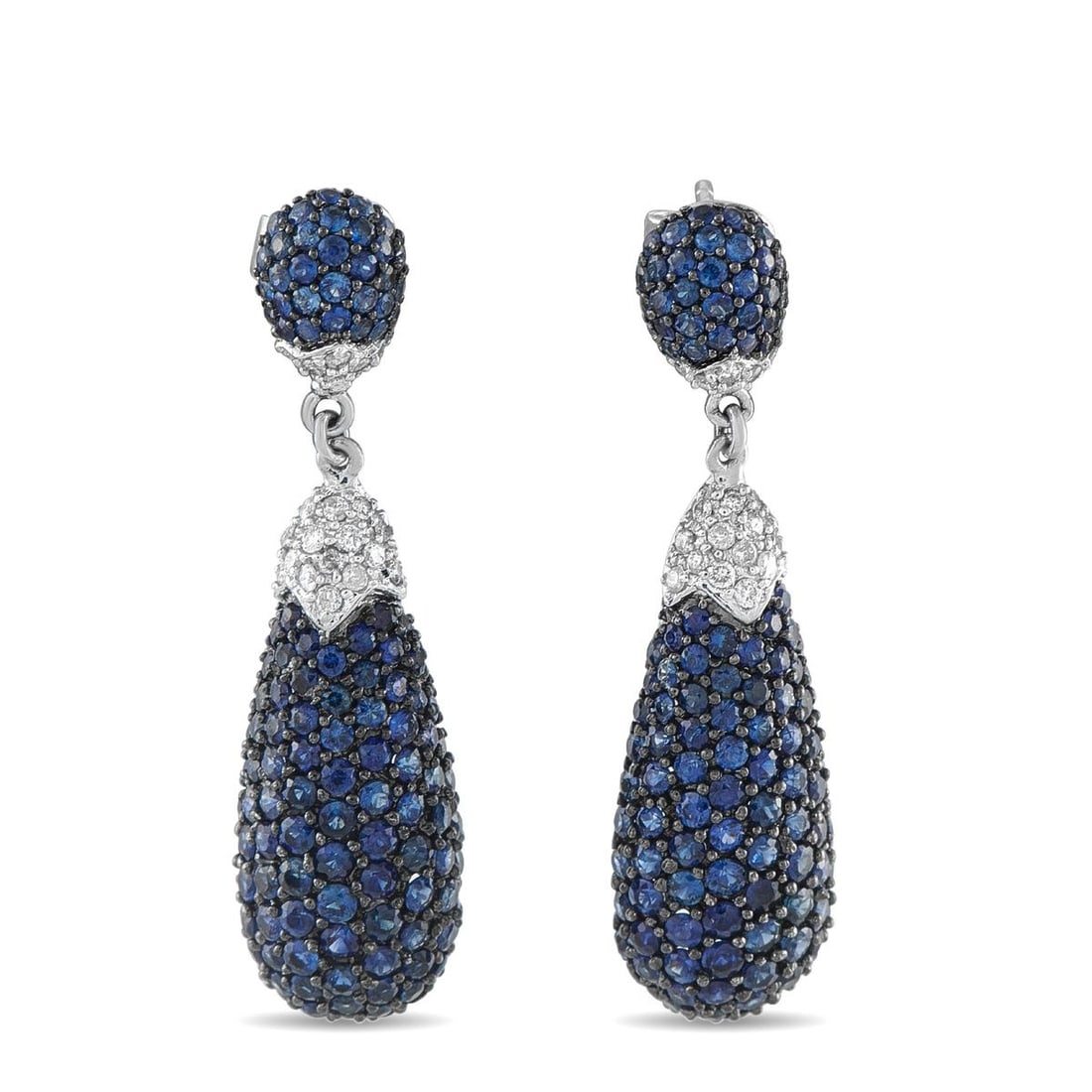 18K WHITE GOLD 0.40CT DIAMOND AND SAPPHIRE DROP EARRINGS: Dramatic and beautifully proportioned, this estate pair of drop earrings cascades with 2.20 carats of intensely blue sapphires across a multi-tiered pave design. Each earring opens with a domed sapphi