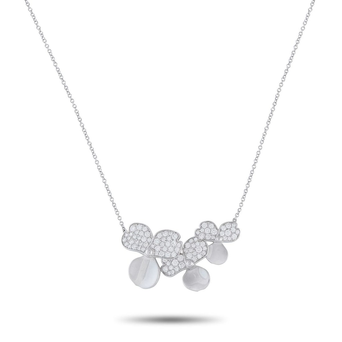 TIFFANY & CO. PAPER FLOWERS PLATINUM DIAMOND PENDANT NECKLACE: This Tiffany & Co. Paper Flowers necklace balances a soft, feminine aesthetic with sleek sophistication. Set in Platinum, the three-petal floral motifs are elevated by dazzling inset Diamonds. The pen