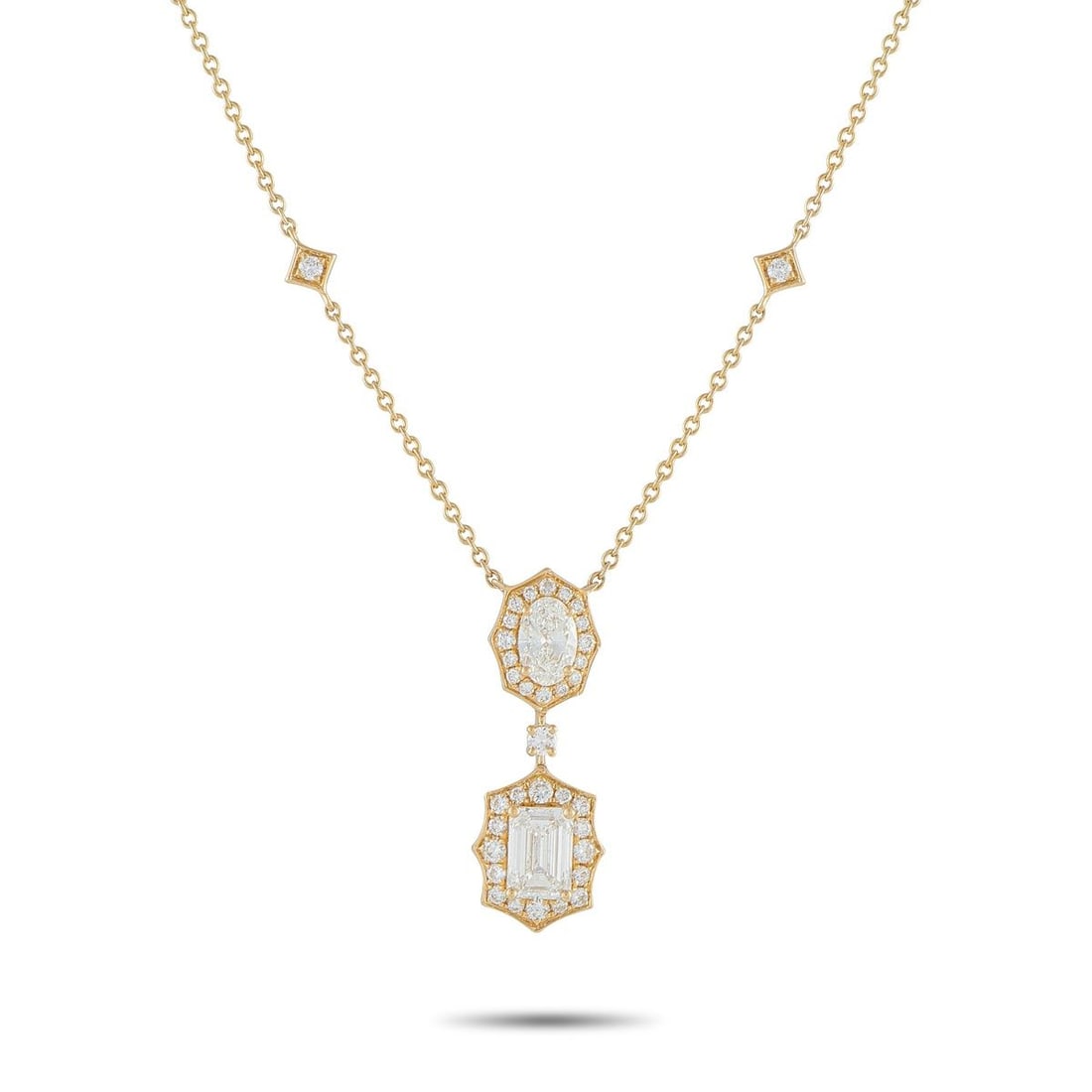 18K YELLOW GOLD 2.76CT DIAMOND GEOMETRIC NECKLACE: Warm yellow gold sets the tone for this necklace, accented by four round diamonds placed along the chain in tilted square frames. The pendant carries an oval diamond outlined by a crisp octagonal halo