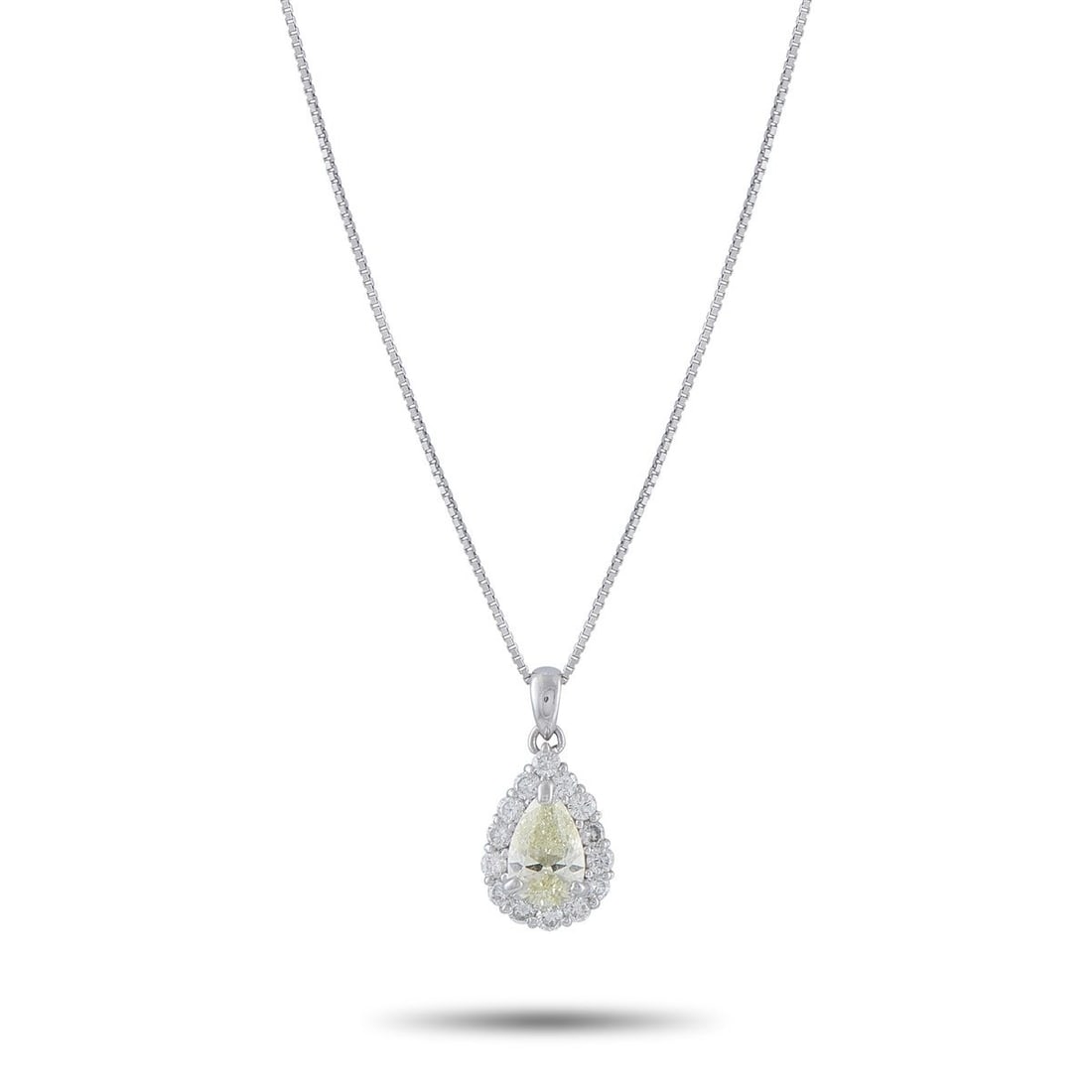 PLATINUM 1.45CT DIAMOND PENDANT NECKLACE: This necklace will add a subtle touch of sparkle to any outfit. Set in Platinum, it features a 1.0 pear shaped Diamond center stone by a halo of Diamonds totaling 0.45 carats. The pendant measures