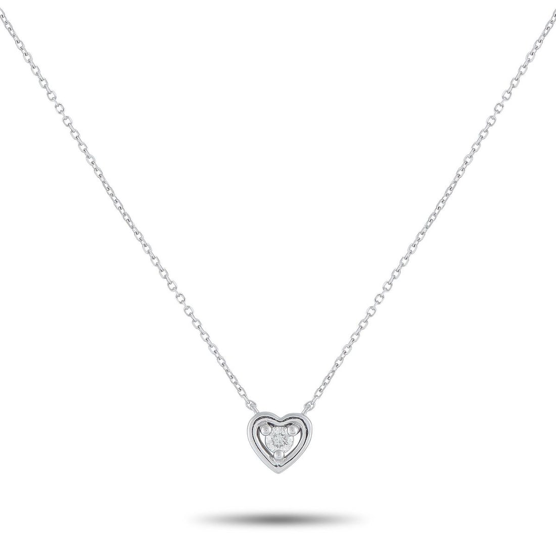 14K WHITE GOLD 0.10CT DIAMOND HEART PENDANT NECKLACE: A single 0.10 carat Diamond makes a statement at the center of this necklaces elegant, understated heart-shaped pendant. Crafted from 14K White Gold, the pendant measures 0.25 round and is suspended f