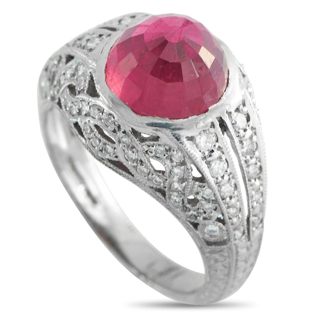 PLATINUM 0.30CT DIAMOND AND RUBELLITE RING: This ring shows ornament held in control. The band is marked 10% Irid Plat, indicating a platinum-iridium alloy with a slightly firmer feel and bright surface. This band forms a multi-split dome, trac