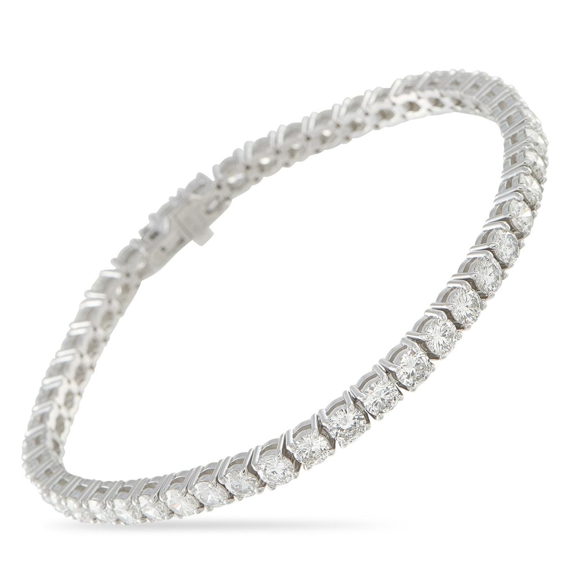 18K WHITE GOLD 9.26CT DIAMOND TENNIS BRACELET: A series of sparkling round-cut Diamonds totaling 9.26 carats make this tennis bracelet simply unforgettable. The timeless design is crafted from 18K White Gold and measures 7.25 long.This jewelry pie