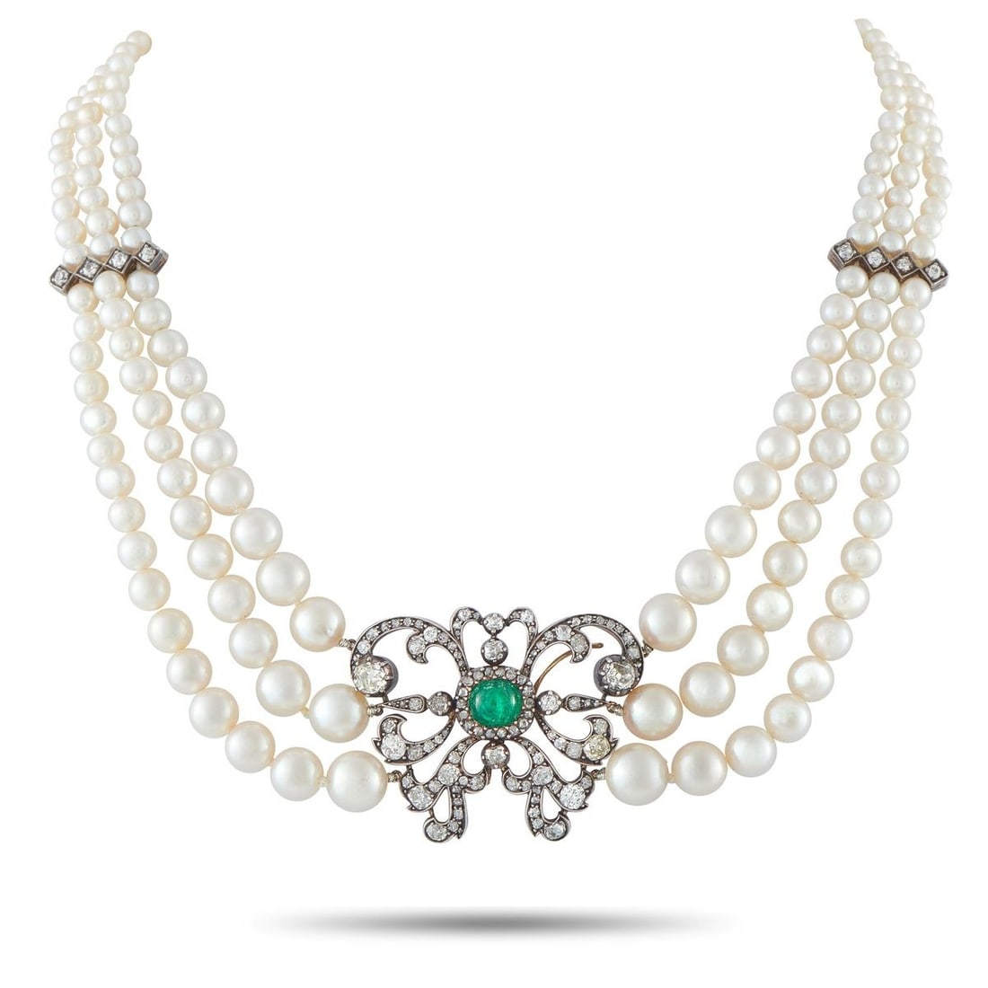 14K ROSE GOLD AND SILVER 4.50CT DIAMOND, EMERALD, AND PEARL NECKLACE: Rooted in vintage design language, this necklace pairs the softness of pearls with the definition of silver and diamonds. Three parallel strands of pearls form the foundation, their lustrous line inte