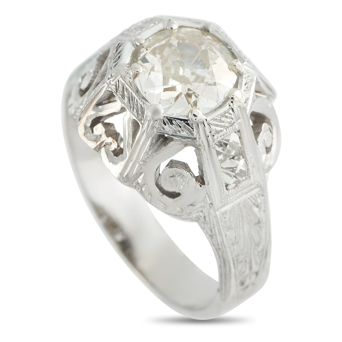18K WHITE GOLD 1.41CT DIAMOND RING: This luxury ring exudes Art Deco elegance. Set in 18K White Gold, the detailed setting is elevated by a sparkling 1.41 carat Diamond center stone. A 4mm wide band and a 6mm top height ensure this piec