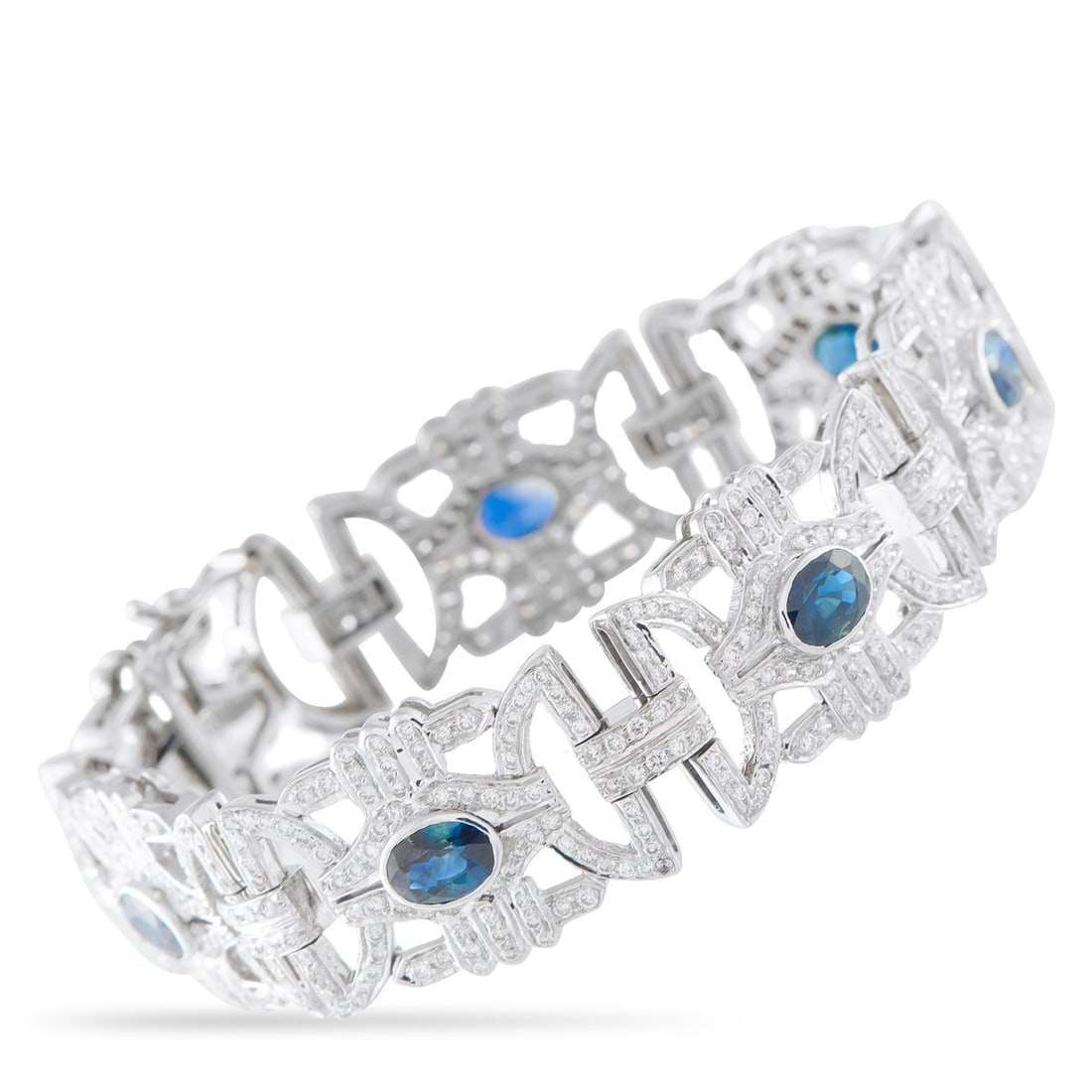 18K WHITE GOLD 4.50CT DIAMOND AND SAPPHIRE BRACELET: An intricate, openwork design makes this bracelet incredibly elegant. Crafted from 18K White Gold, Diamonds with a total weight of 4.50 carats highlight all this pieces intricacies. At the center, Sap