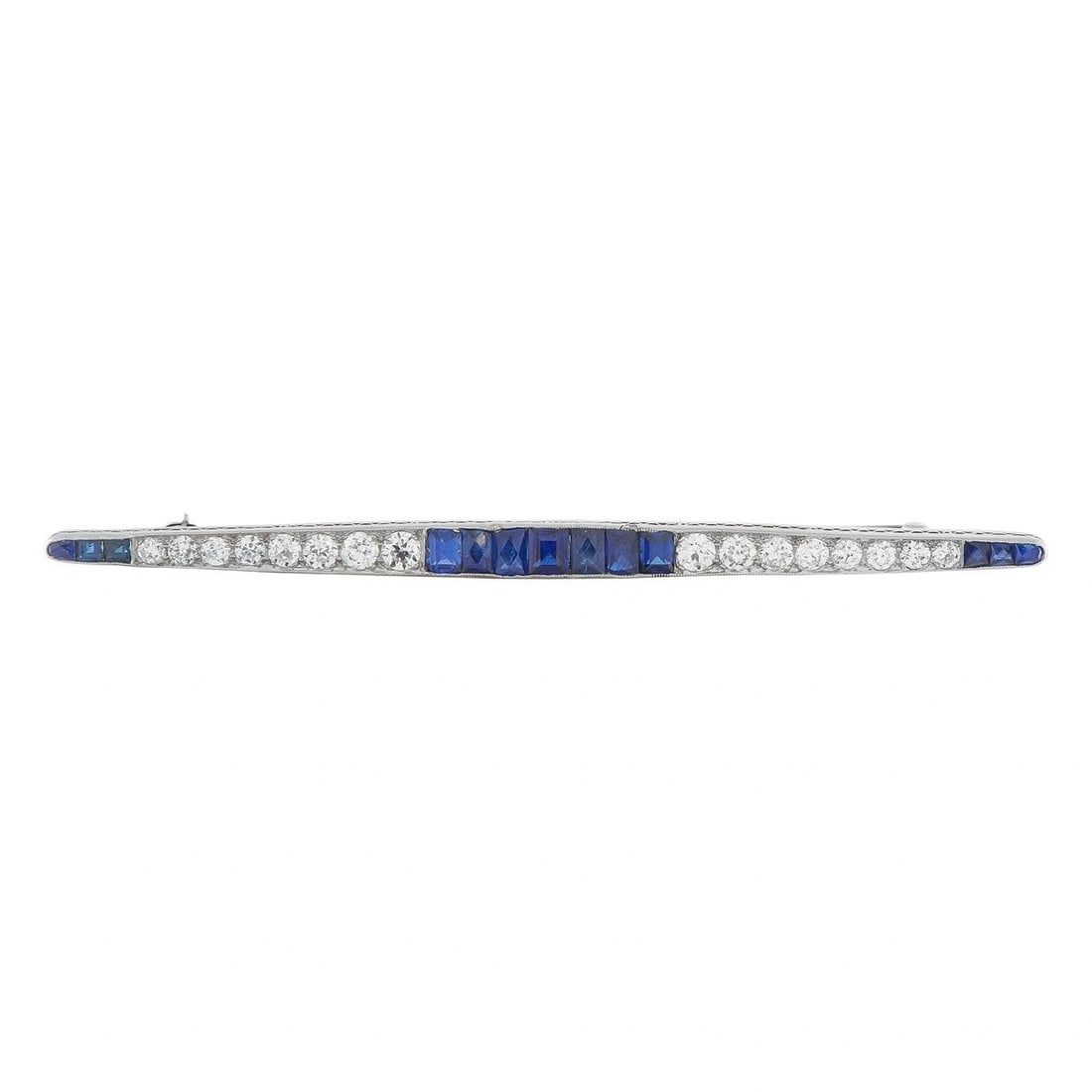 PLATINUM 1.50CT DIAMOND AND SAPPHIRE ART DECO PIN: A sleek, sophisticated design ensures this luxury brooch will never go out of style. The Platinum setting features classic Art Deco design elements. Diamonds with a total weight of 1.50 carats are per